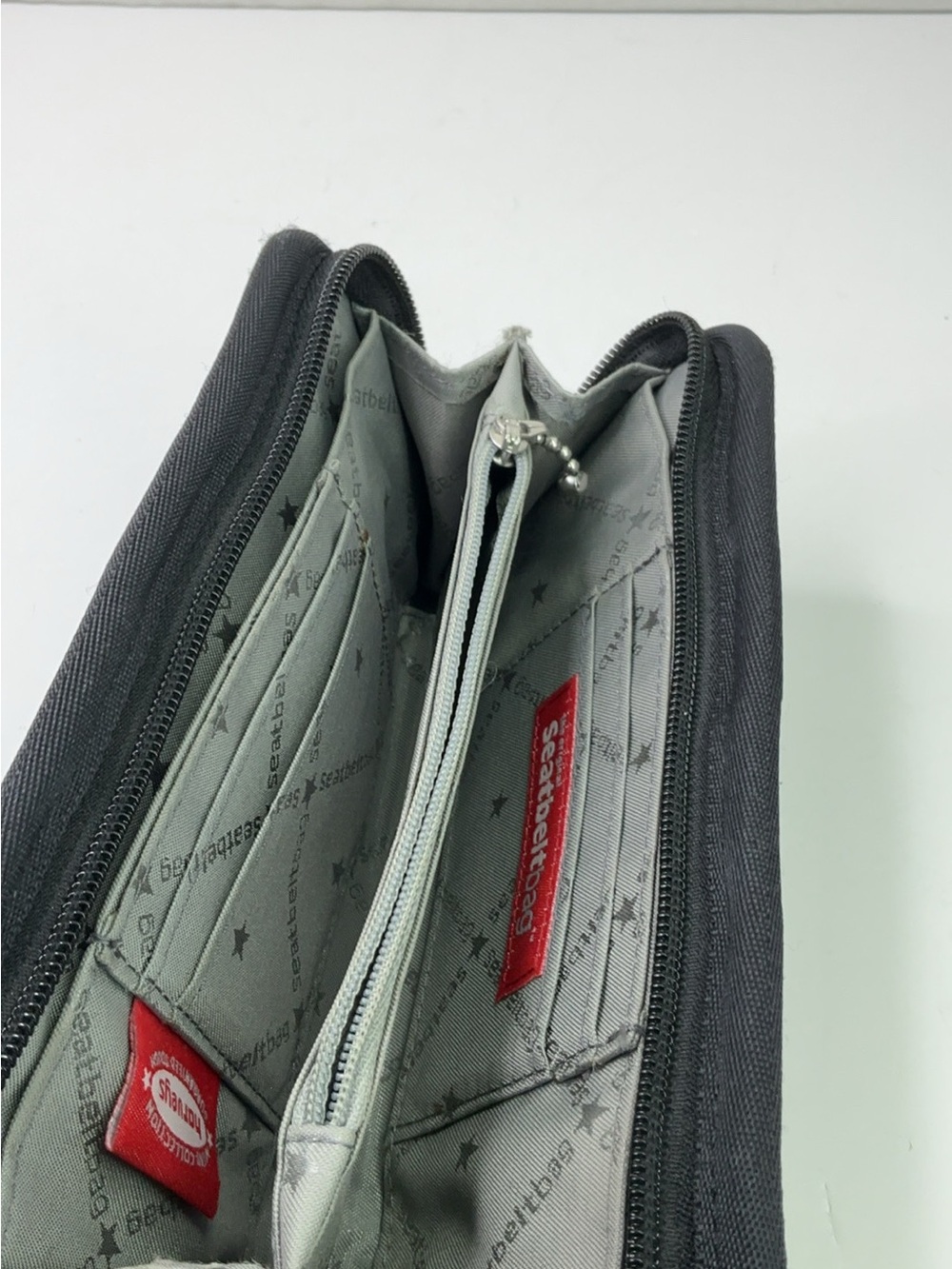 Harveys Seatbelt Bag wallet features black woven webbing and a gray. - Picture 9 of 11